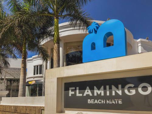 a sign for the flamingo beach market in front of a building at Flamingo Beach Mate in Adeje
