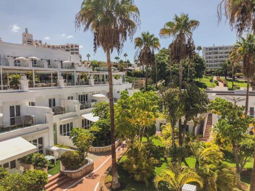 an aerial view of a large white building with palm trees at Flamingo Beach Mate in Adeje