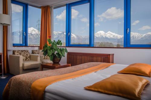 a bedroom with a bed with a view of mountains at Garni Hotel Azul in Kranj