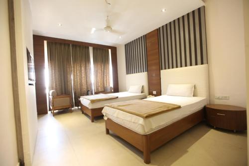 a hotel room with two beds in a room at Hotel Landmark in Chandīgarh