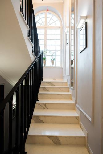 a staircase with black railings and a window at Willa Krakowska in Raszyn
