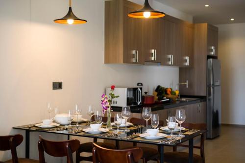 a dining room with a table with wine glasses at Residence 105 Hotel and Apartment in Phnom Penh
