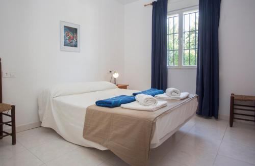 a bedroom with a bed with towels on it at Casa Tordos in Jávea