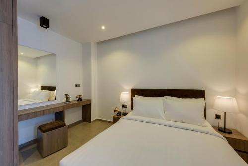 a bedroom with a large bed and a mirror at Residence 105 Hotel and Apartment in Phnom Penh