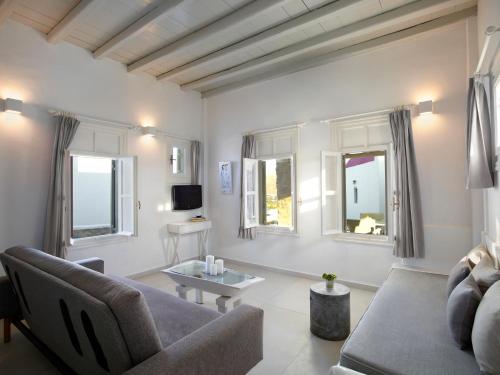 a living room with a couch and a table at Kallos of Mykonos - previous Leonis Summer Houses in Ornos