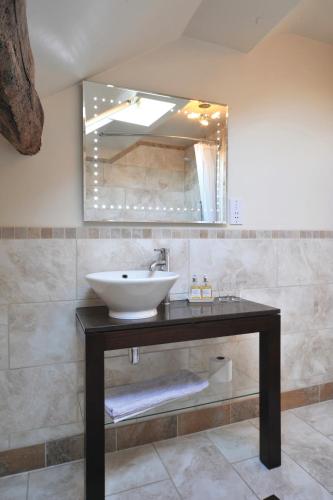 a bathroom with a sink and a mirror at Priory hotel in Cartmel