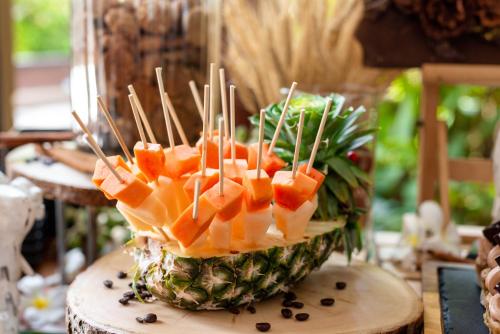 a pineapple with fruit skewers sticking out of it at Mövenpick Asara Resort & Spa Hua Hin in Hua Hin