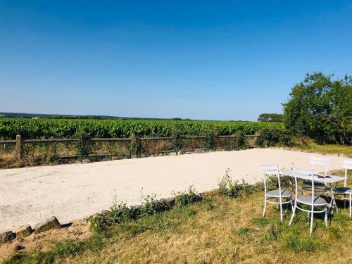 a table and chairs sitting on a beach at Côte du Jardin in Pouillé