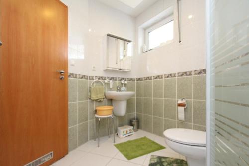 a bathroom with a toilet and a sink at Apartamenty Solar in Wisła