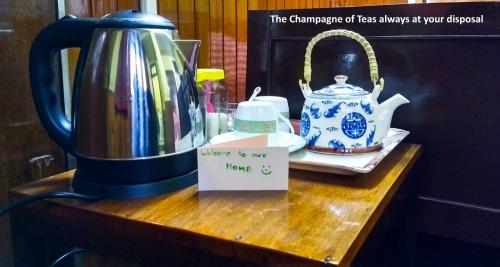 a table with a jug and a tea pot on it at West Point Backpackers Hostel in Darjeeling