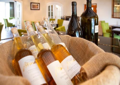 a bunch of bottles of wine in a basket at Hotel Annaberg in Bad Dürkheim