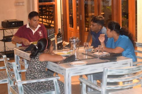 a group of people sitting around a table at Olinia Airport Hotel in Katunayake