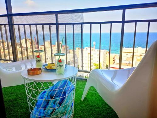 a table and chairs on a balcony with a view of the ocean at Golden Blue Arenales in Arenales del Sol