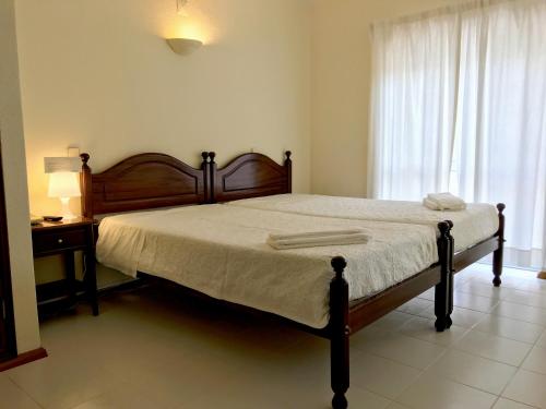 1 dormitorio con cama, mesa y ventana en Angelus, en Fátima