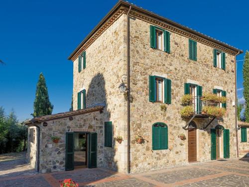a large stone building with green shutters on it at Belvilla by OYO Casa del Re in Le Piazze