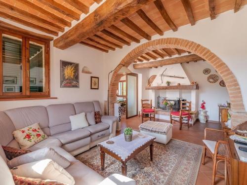 a living room with a couch and a table at Belvilla by OYO Casa del Re in Le Piazze