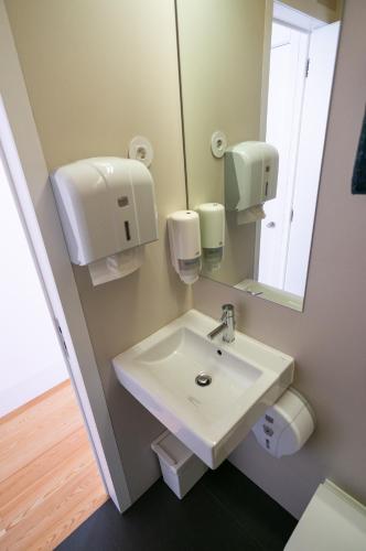 a bathroom with a sink and a mirror at Change The World Hostels - Coimbra - Almedina in Coimbra