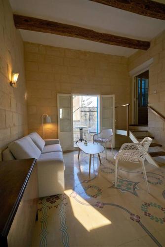 a living room with a couch and a table at Magic in the Heart of Old Gozo (Penthouse) in Victoria