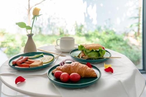 a table with three plates of food on it at Su Jiu Apartment in Nanning