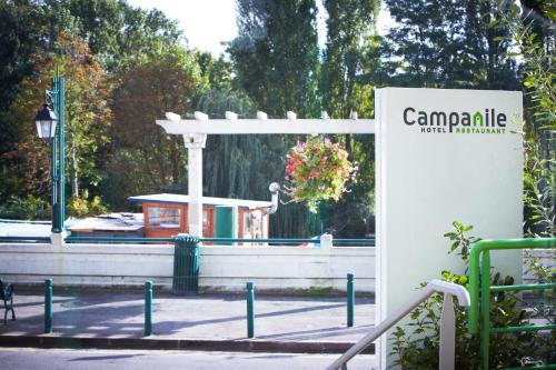 a sign for a park with a building in the background at Campanile Nogent-Sur-Marne in Nogent-sur-Marne