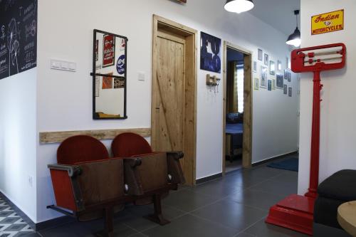 a waiting room with red chairs and a door at Dundee's Point in Szentendre