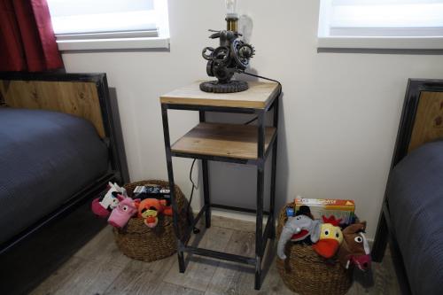 two baskets with stuffed animals on them next to a table at Dundee's Point in Szentendre