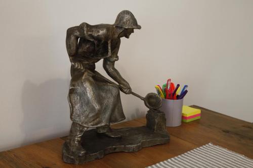 a bronze statue of a woman playing with a child at Dundee's Point in Szentendre