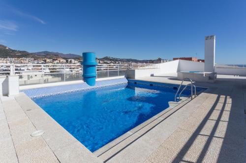 a swimming pool on the roof of a building at Apartamento Marbella Centro Av. del Mar in Marbella