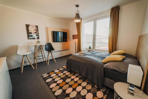 a bedroom with a bed and a large window at Beautiful new studio, 400m from the square in Plzeň