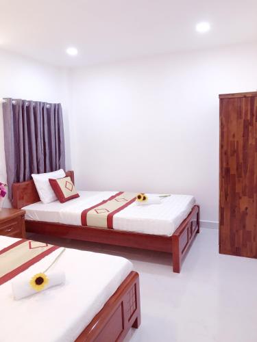 a room with two beds with flowers on them at Aurora Hotel in Ho Chi Minh City