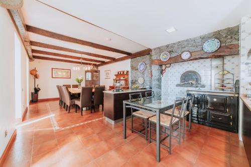 a kitchen and dining room with a table and chairs at Villa Sol by Amazing Madeira in Ponta do Sol
