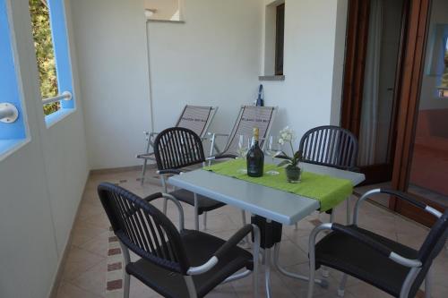 a table with chairs and a table with a green table cloth at Villaggio Mare Blu in Bibione