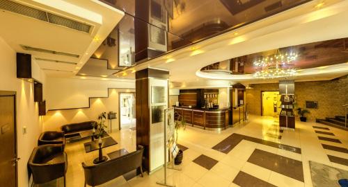 a lobby of a building with a couch and a kitchen at Hotel Forum - Free Parking for cars in Sofia