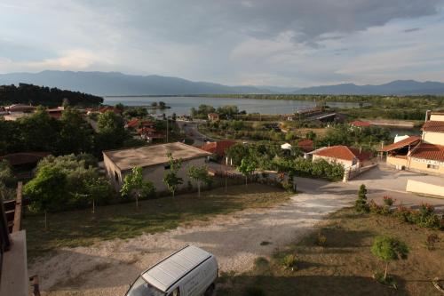 a white van parked on a road next to a body of water at Guesthouse To Fragma in Lithótopos
