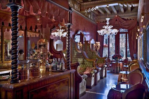 a room with a bar with chairs and mirrors at Al Ponte Antico in Venice