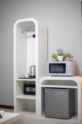 a white shelf with a microwave on top of it at HotSpot @ City Centre by SSVC in Kota Kinabalu