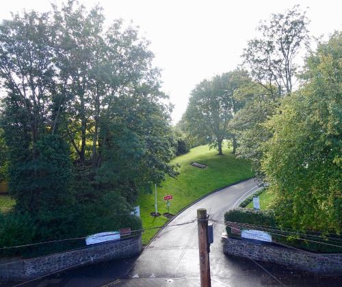 a bridge over a canal with a road and trees at Abinger Guest House in Leicester