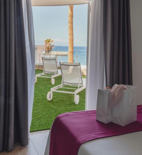 a room with two chairs and a view of the ocean at Flamingo Beach Mate in Adeje
