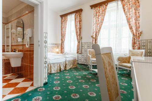 a hotel room with a bed and a bathroom at Hotel Klarinn Prague Castle in Prague