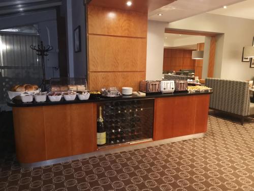 a lobby with a counter with bottles of wine at Best Western Kings Manor in Edinburgh
