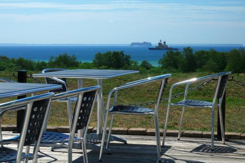 a group of tables and chairs with the ocean in the background at Sundsgården hotell & konferens in Helsingborg
