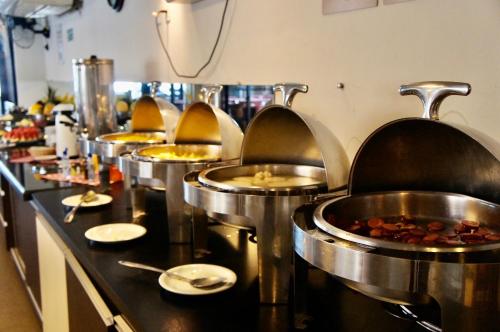 a row of food stations in a restaurant kitchen at Bessa Beach Hotel in João Pessoa