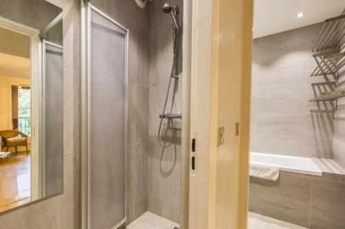a bathroom with a shower and a tub at Apartment Gentianes 1 in Chamonix-Mont-Blanc
