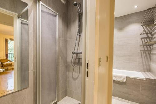 a bathroom with a shower and a tub at Apartment Gentianes 1 in Chamonix