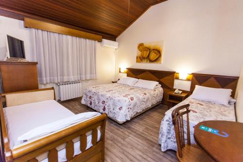 Ліжко або ліжка в номері Tri Hotel Lago Gramado