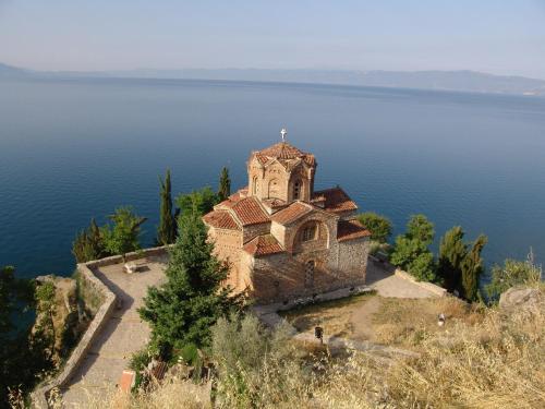 an old church on an island in the water at Hotel Nova Riviera in Ohrid