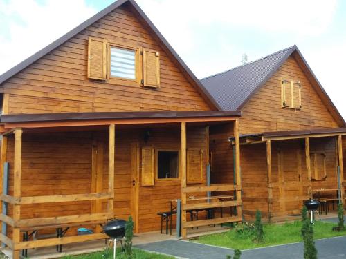 a log cabin with a gambrel roof at Bungalow with a sunny terrace in Międzyzdroje