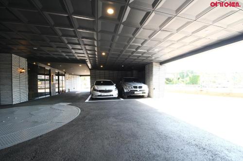 a garage with two cars parked in it at Stay Month Hotel in Goyang