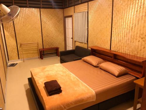 a bedroom with a large bed and a couch at Rock View Terrace in Ko Jum