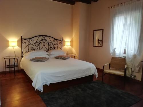 a bedroom with a large bed with white sheets and pillows at Locanda degli Ulivi in Arcugnano